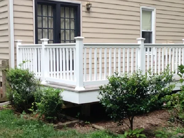 White deck with railing and landscaping