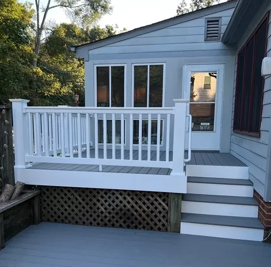 Modern blue house with white deck railing