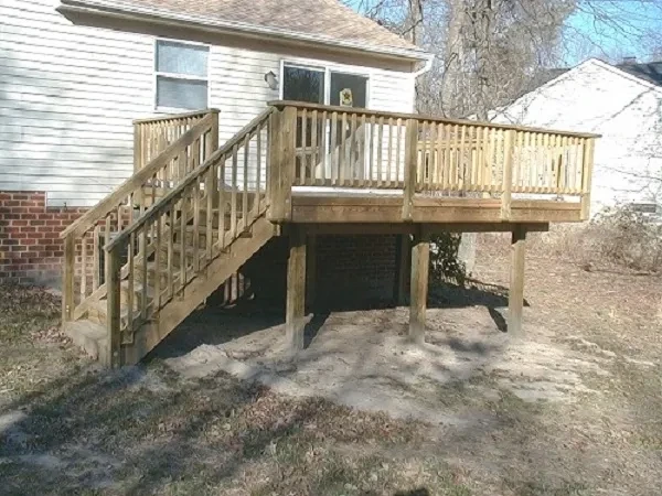 Wooden deck with stairs attached to house