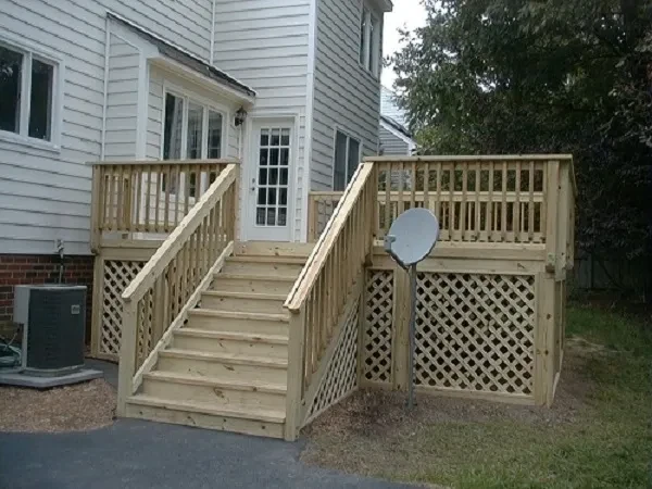 Wooden deck with stairs and white house