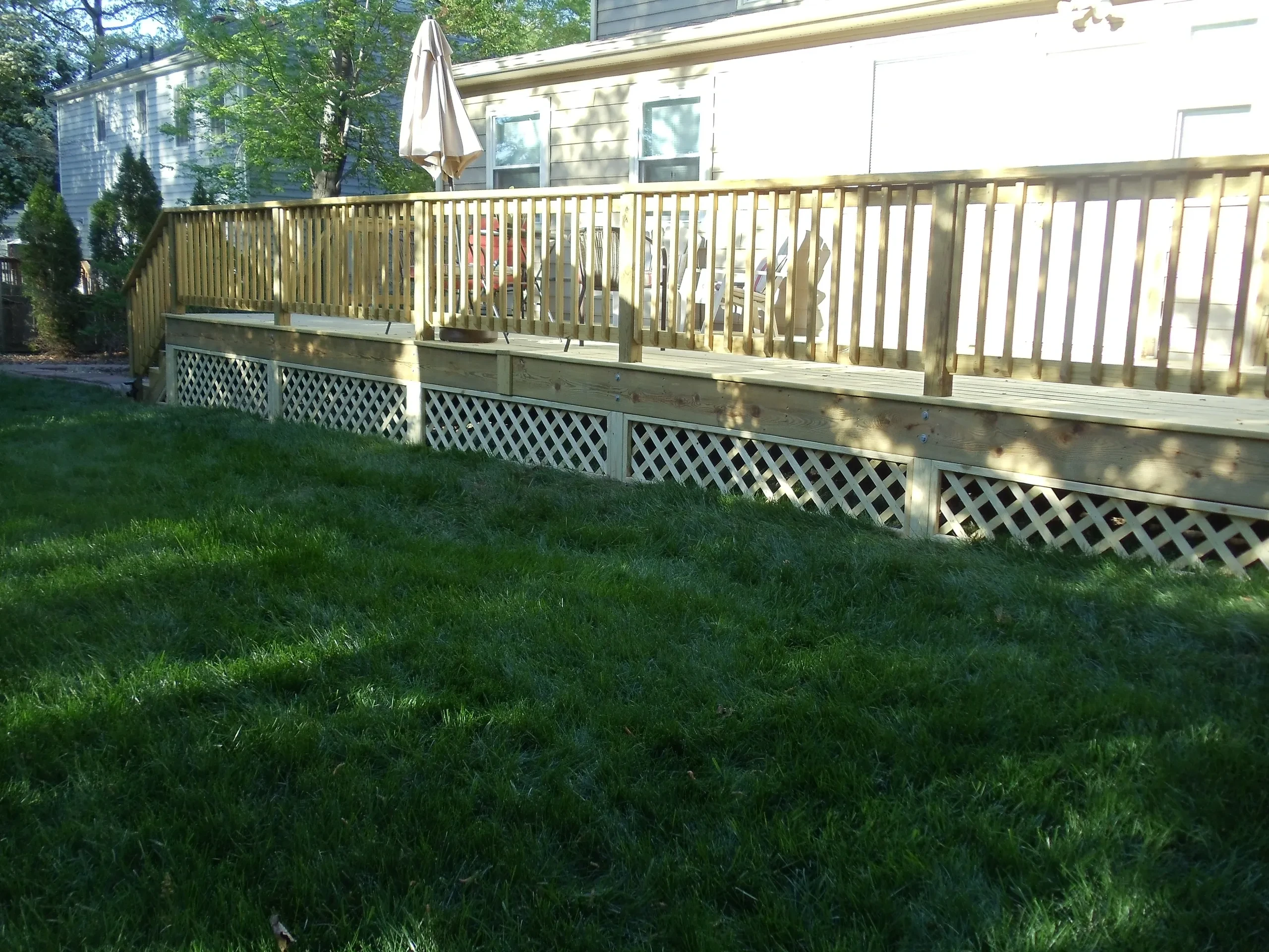 Wooden deck with lattice skirting backyard