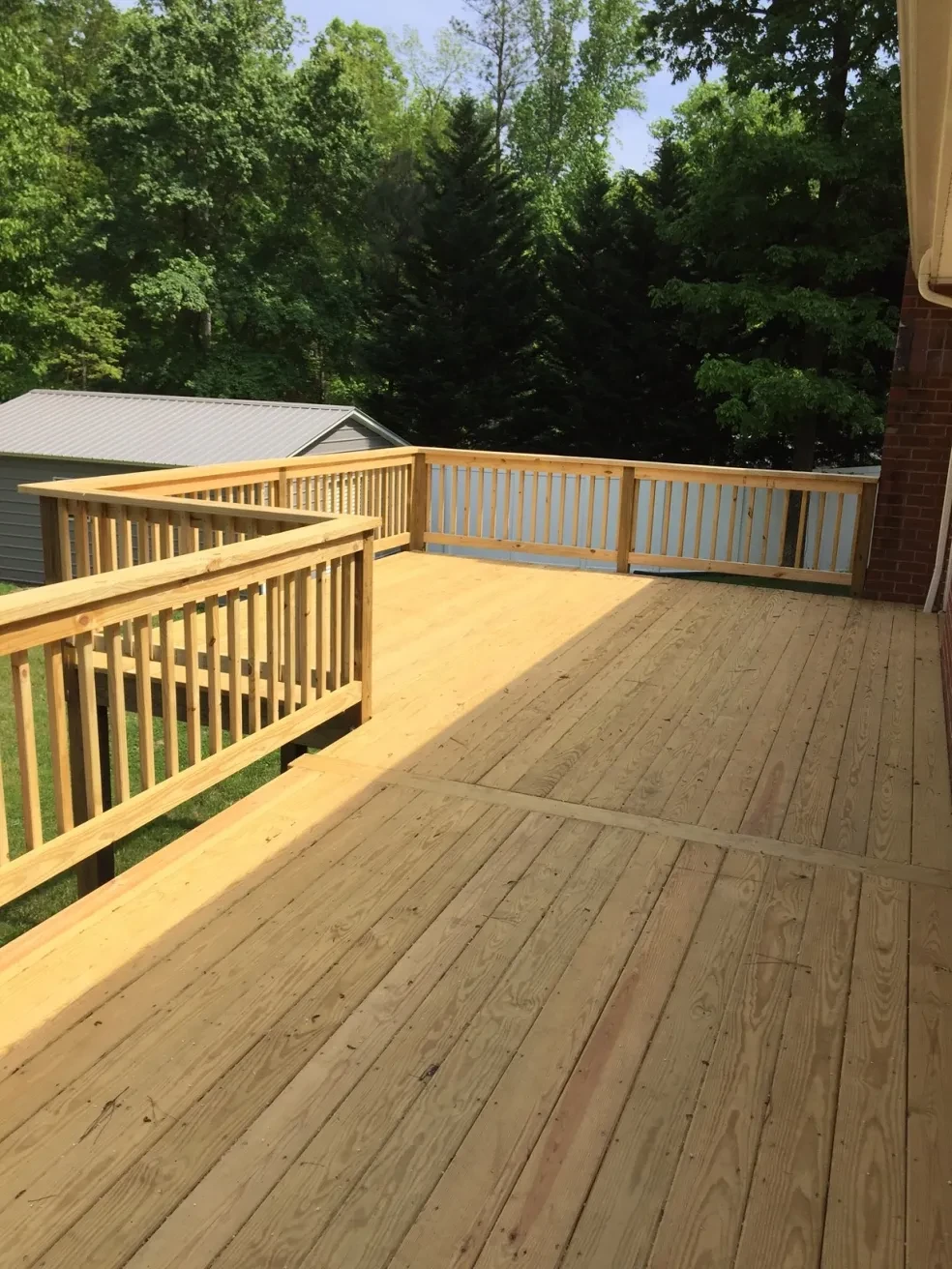 Wooden deck with yellow railings forest