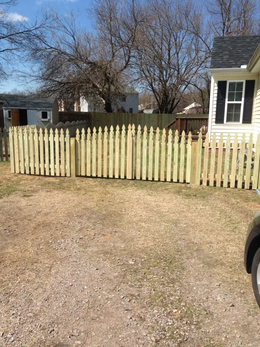 White picket fence residential yard spring