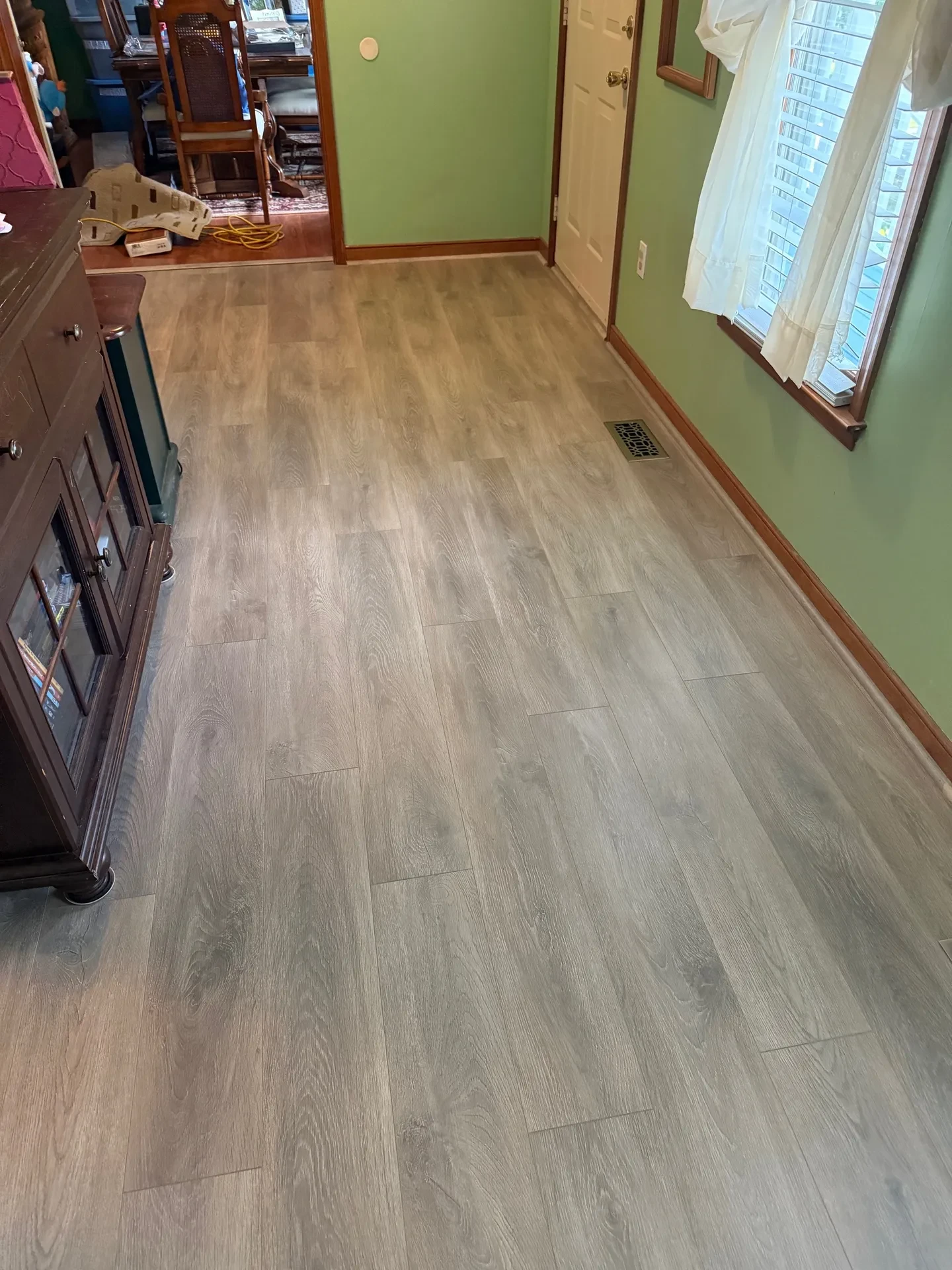Home interior with laminate flooring green walls