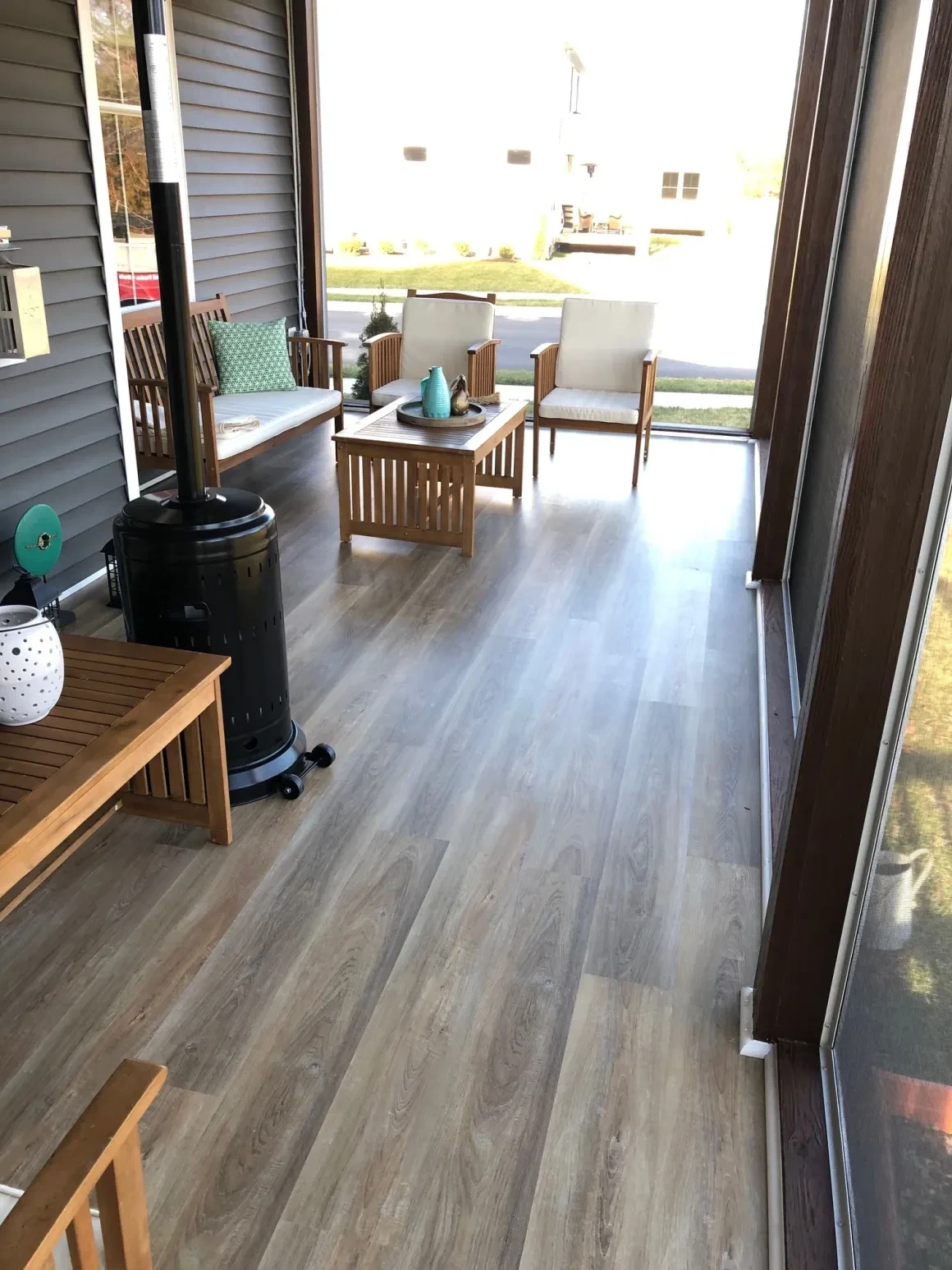 Modern patio with wooden furniture and lake view