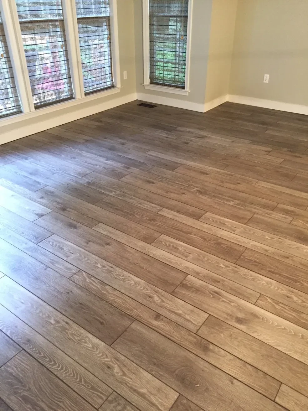 Empty room hardwood flooring large windows