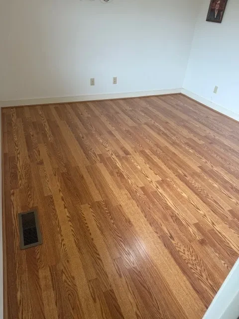 Empty room with wood flooring