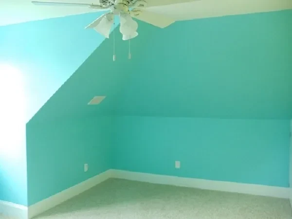 Empty room turquoise walls ceiling fan