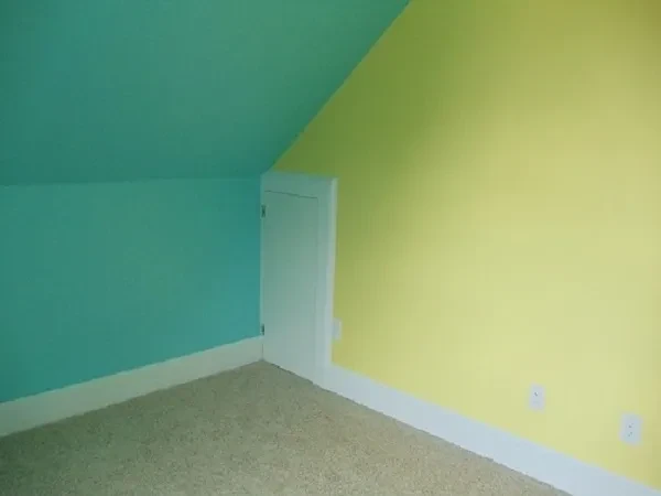 Empty room turquoise yellow walls door