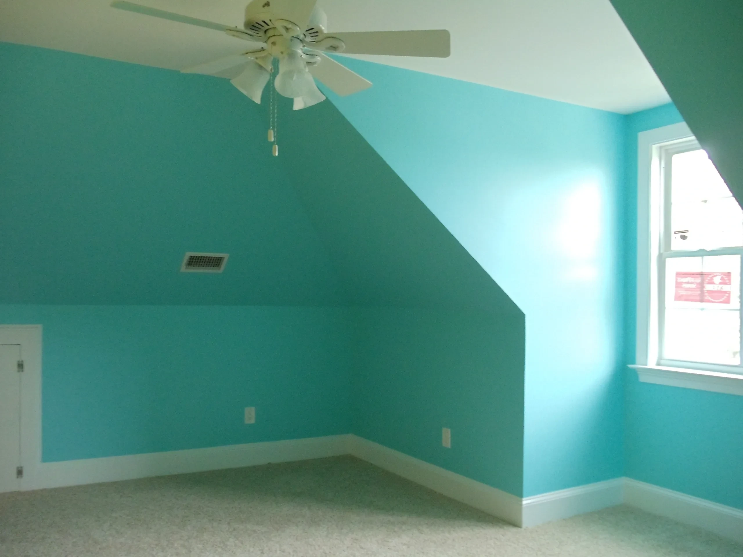 Turquoise bedroom with ceiling fan and window