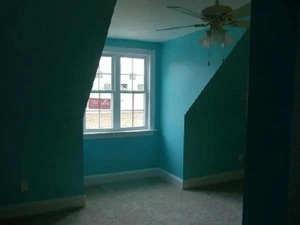 Turquoise bedroom with window and ceiling fan