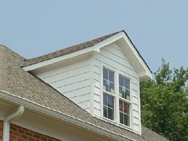 Brick house dormer window with white trim