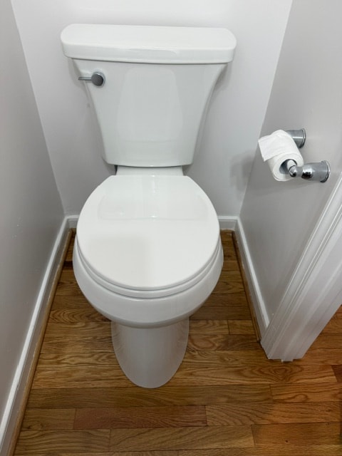 White toilet with paper holder bathroom