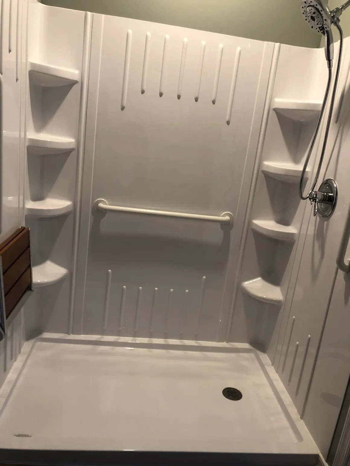 Modern white shower stall with built-in shelves