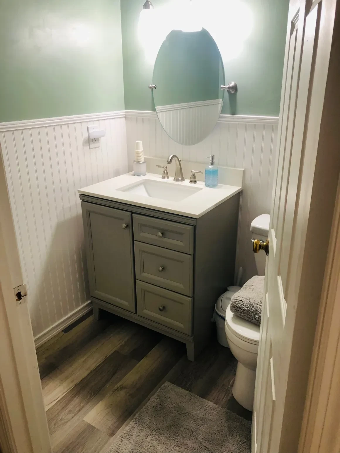 Modern bathroom with green walls and vanity
