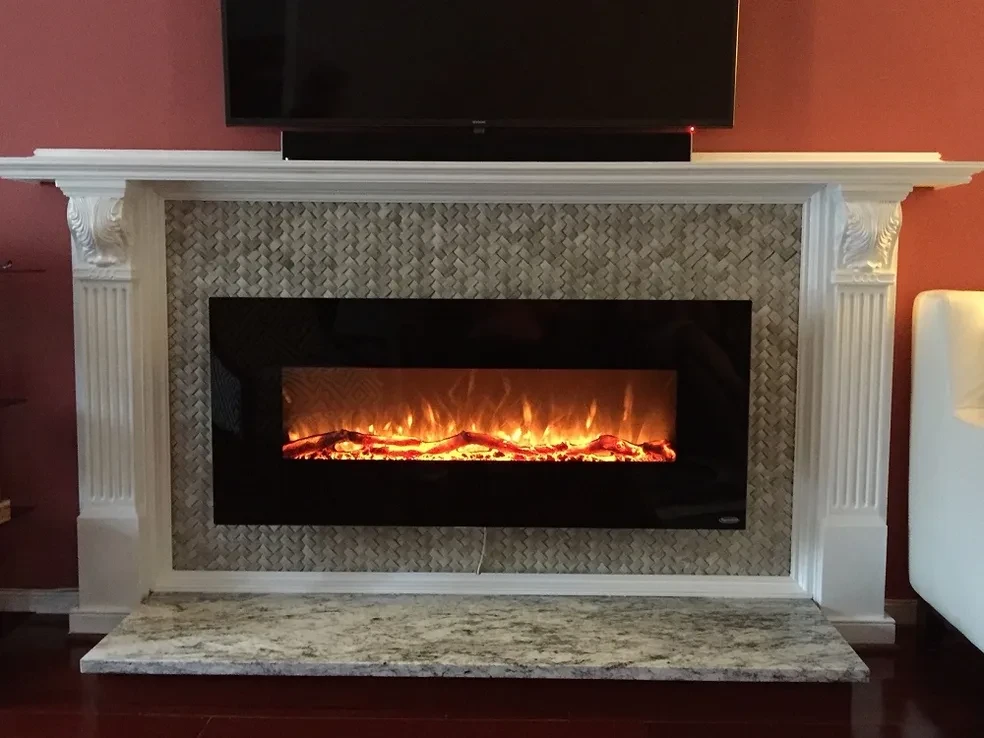 Electric fireplace in white mantel with TV above