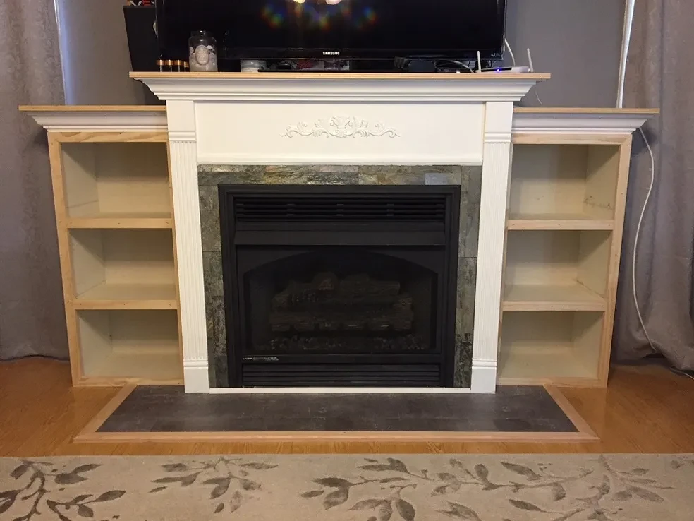 Fireplace with built-in wooden shelving units