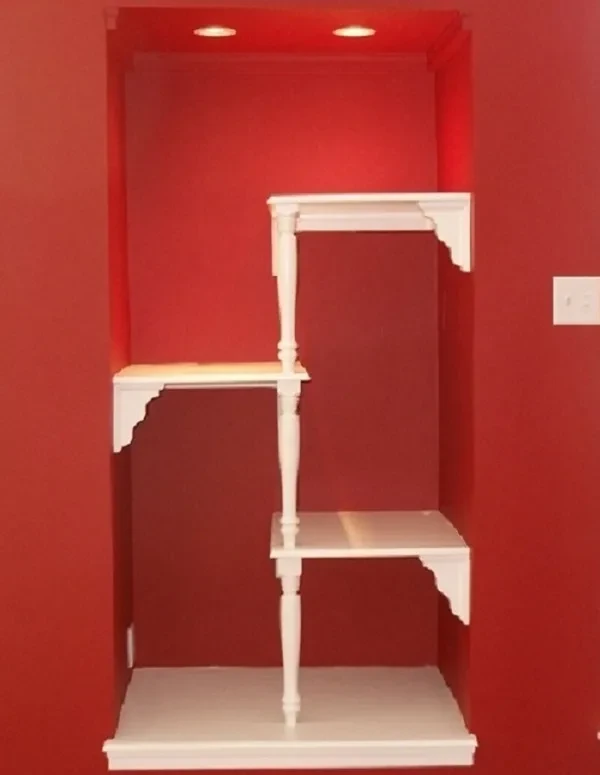 White shelving unit with red wall niche