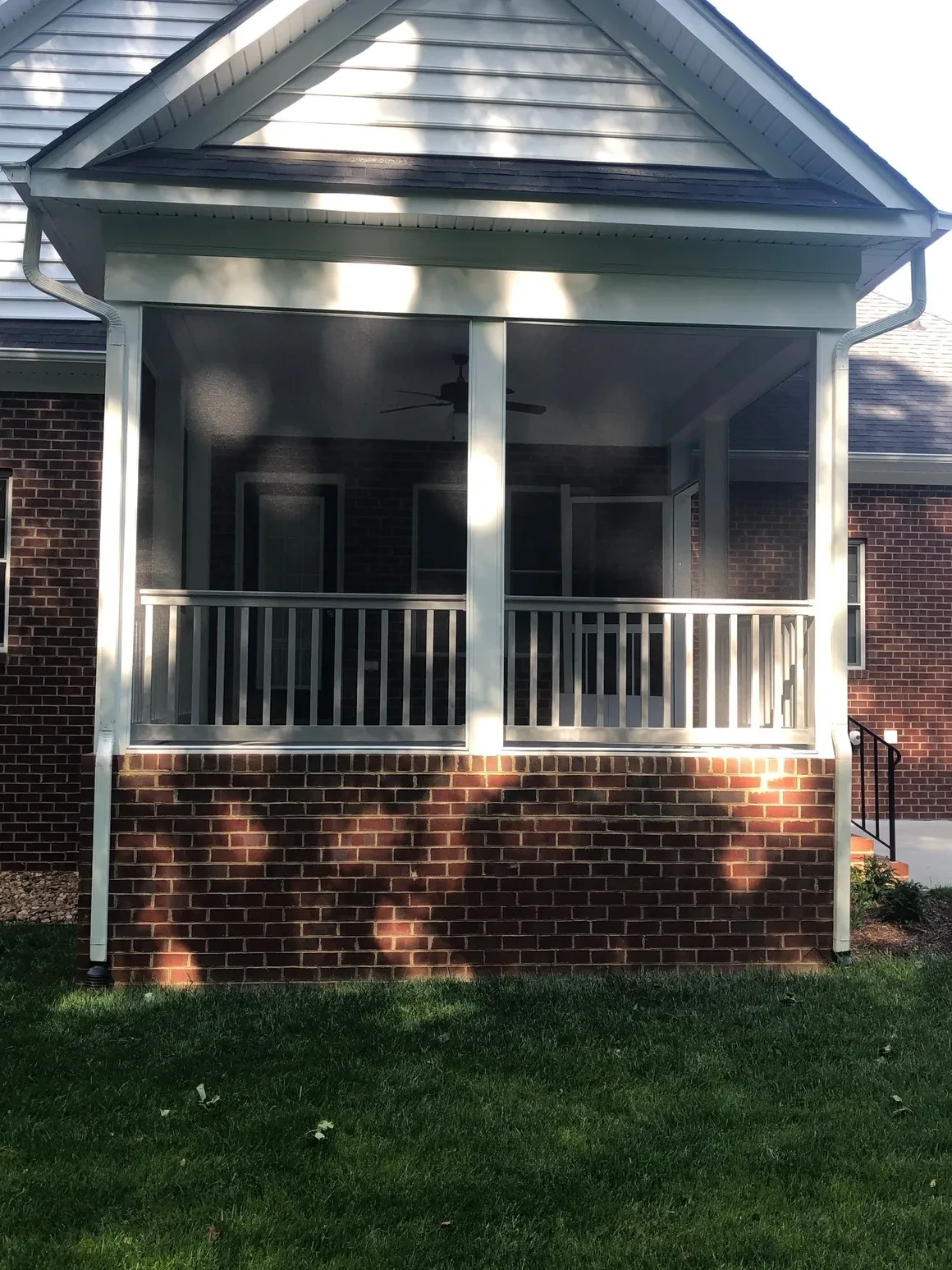 Modern brick porch with white railings