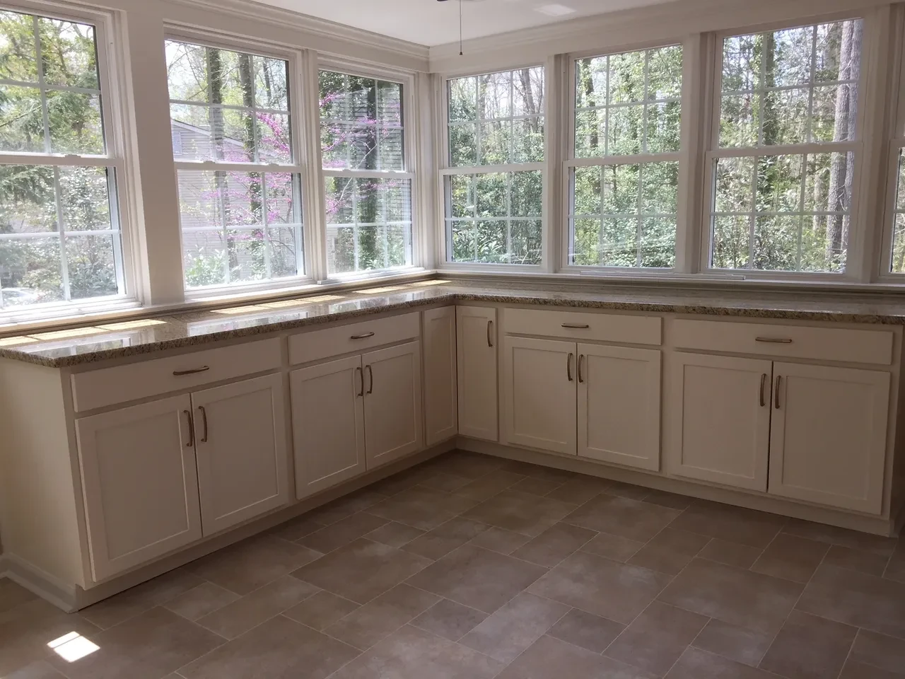 Screened porch with large windows and outdoor views