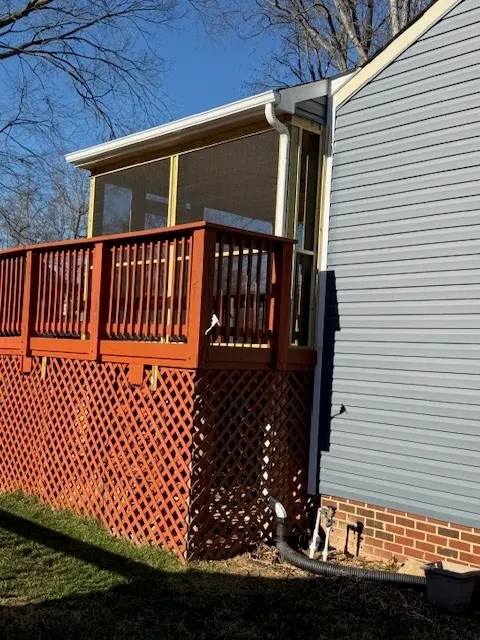 Modern sunroom addition with orange deck