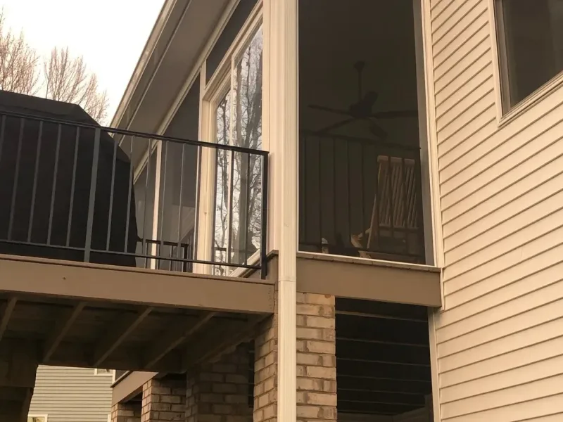 Porch enclosure with screen panels and lattice wood trim