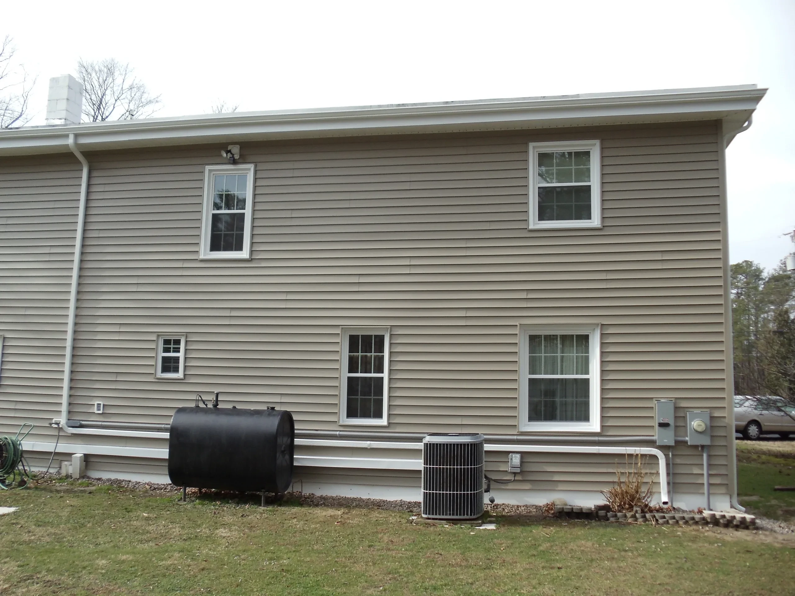 Beige siding house with HVAC units exterior