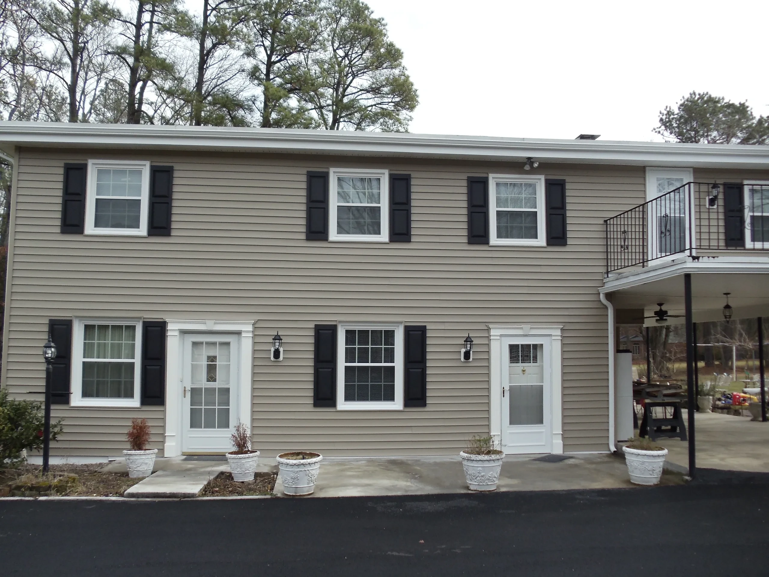 Modern two-story house with black shutters siding