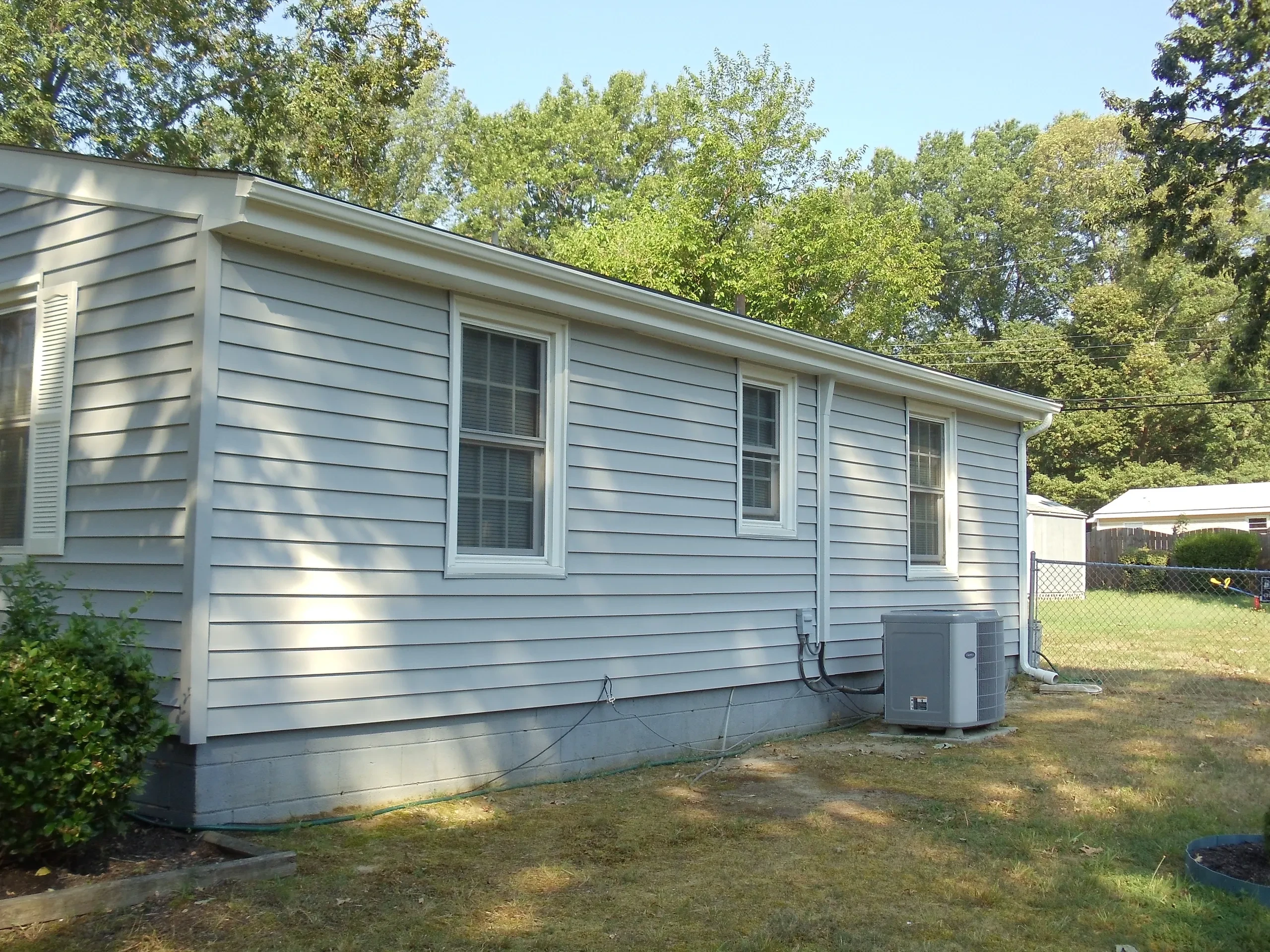 White mobile home surrounded by trees