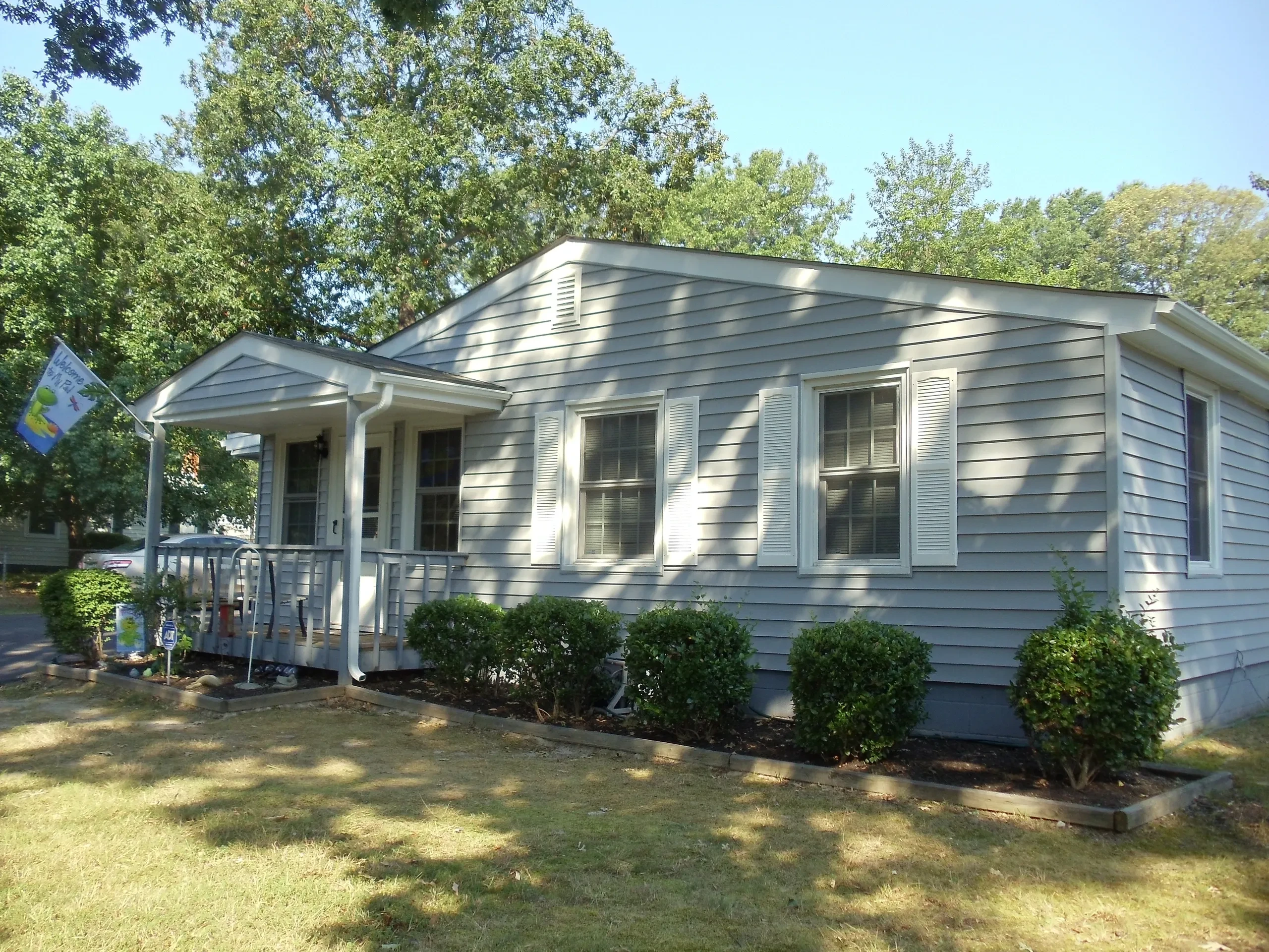 White mobile home with front porch