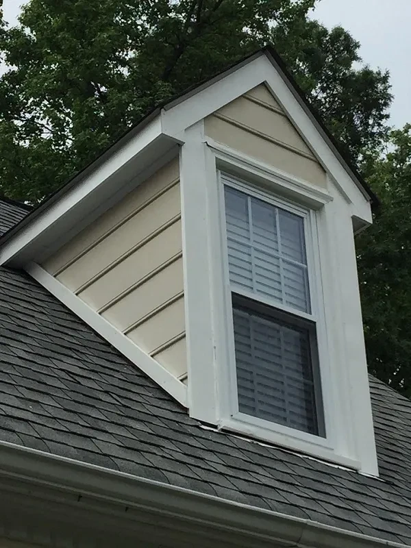 White dormer window on shingled roof