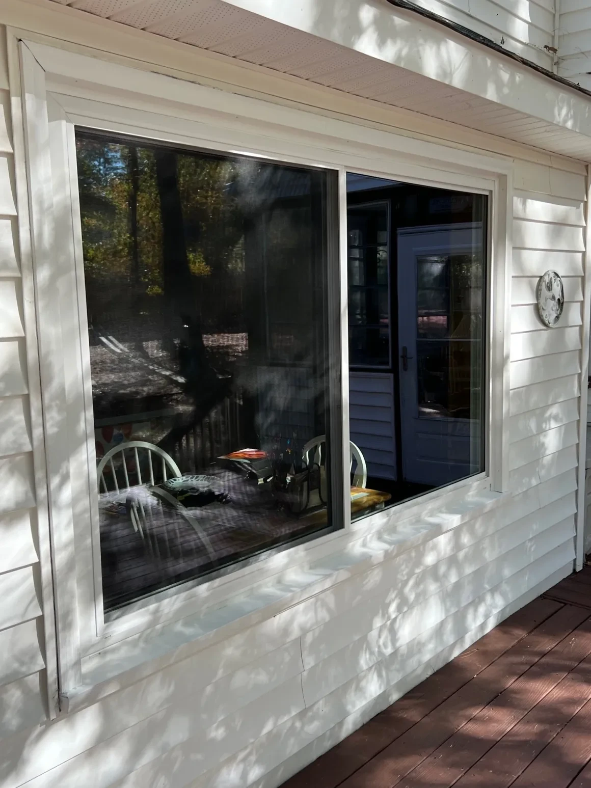 Large windows reflecting outdoor patio furniture